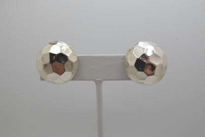 Pair of silver round stud earrings on a gray background