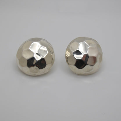 Pair of silver round earrings on a light gray background