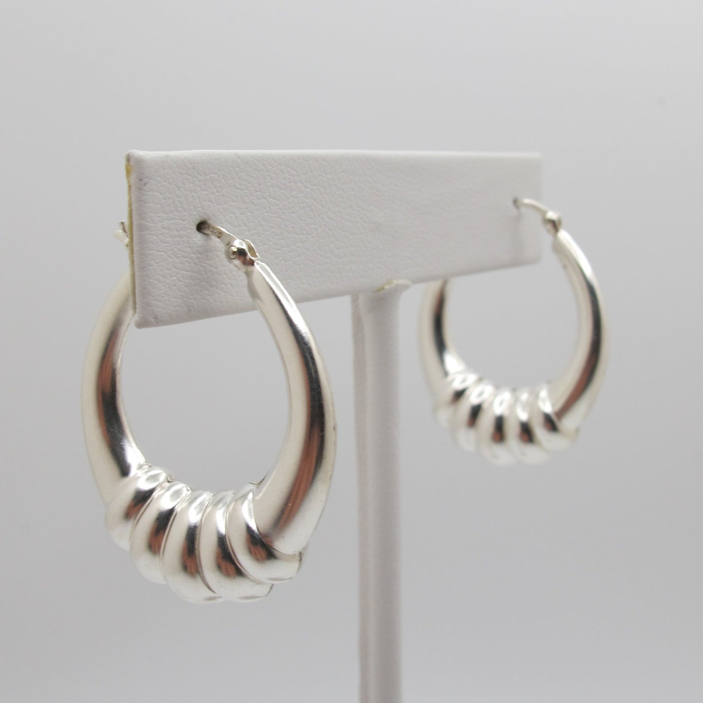 Silver hoop earrings on a white background